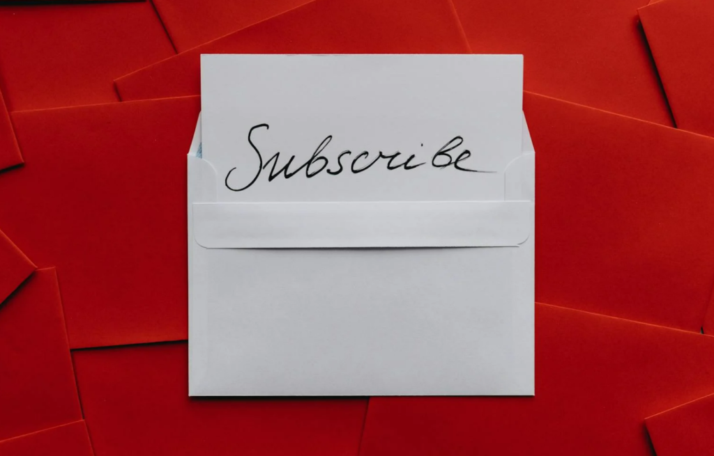 Card on top of red envelopes saying 'subscribe'