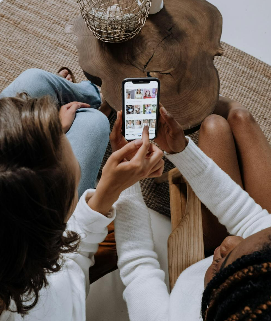 Two people scrolling through a social media feed